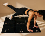 Dani in push-up position with one leg raised on black Precision Mat thumbnail