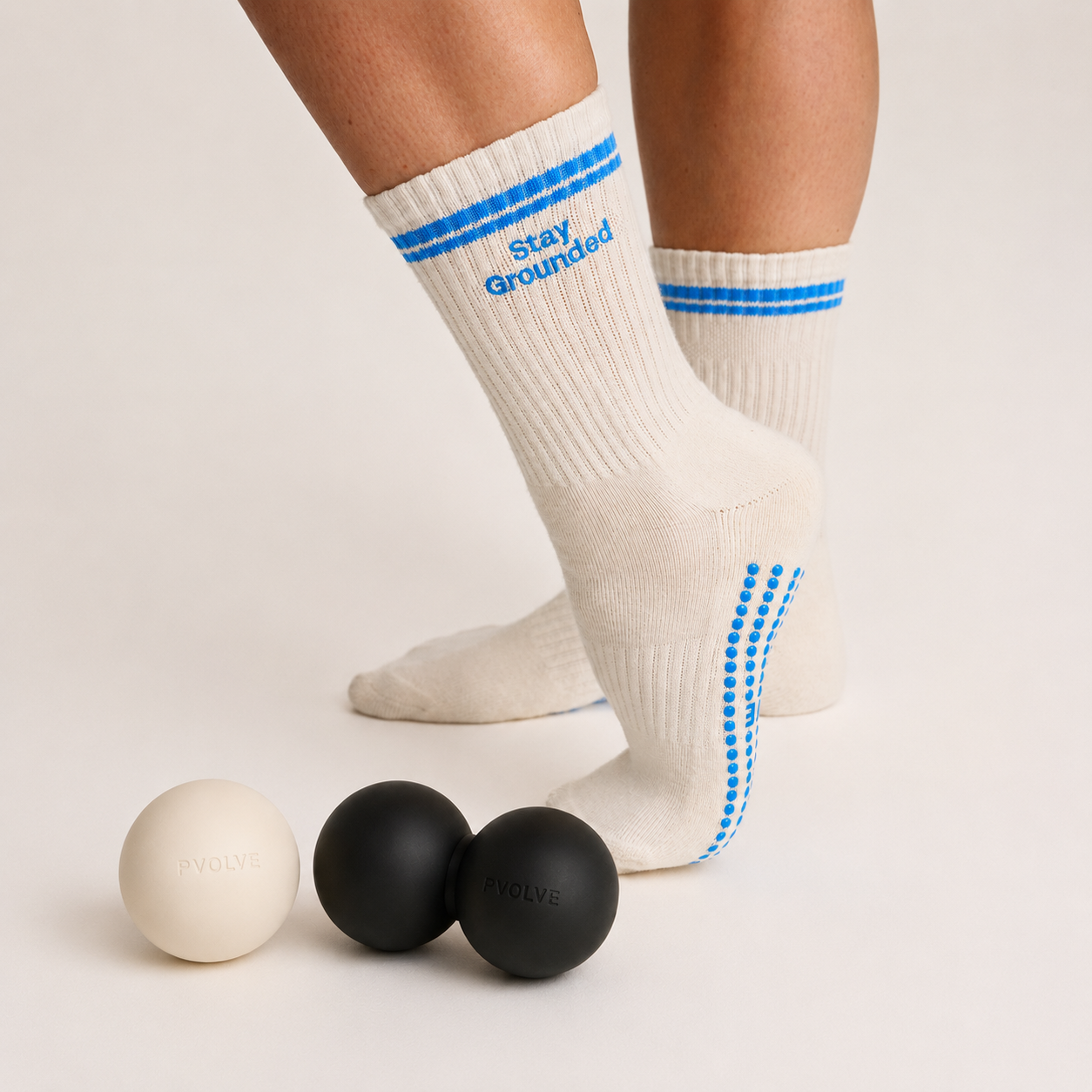 A black Pvolve P.band, a resistance band with grips for the left and right hands, on a white background.